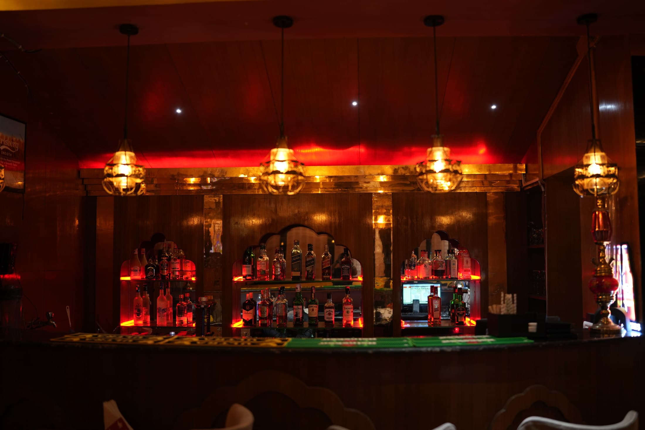 bistro Y bar counter with niches and brass lanterns